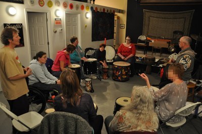 group of people in a circle with drums