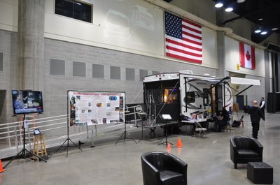 RPG Research van in a warehouse underneath American Flag